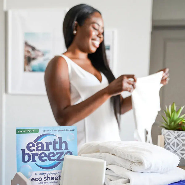 Folding fresh laundry with Earth Breeze eco sheets